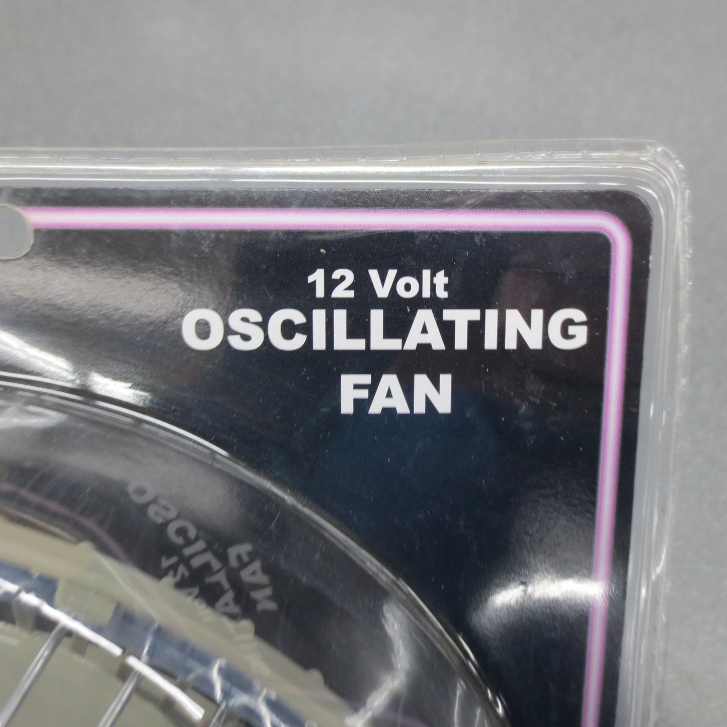 12 Volt Oscillating Fan packaging with label on a gray background