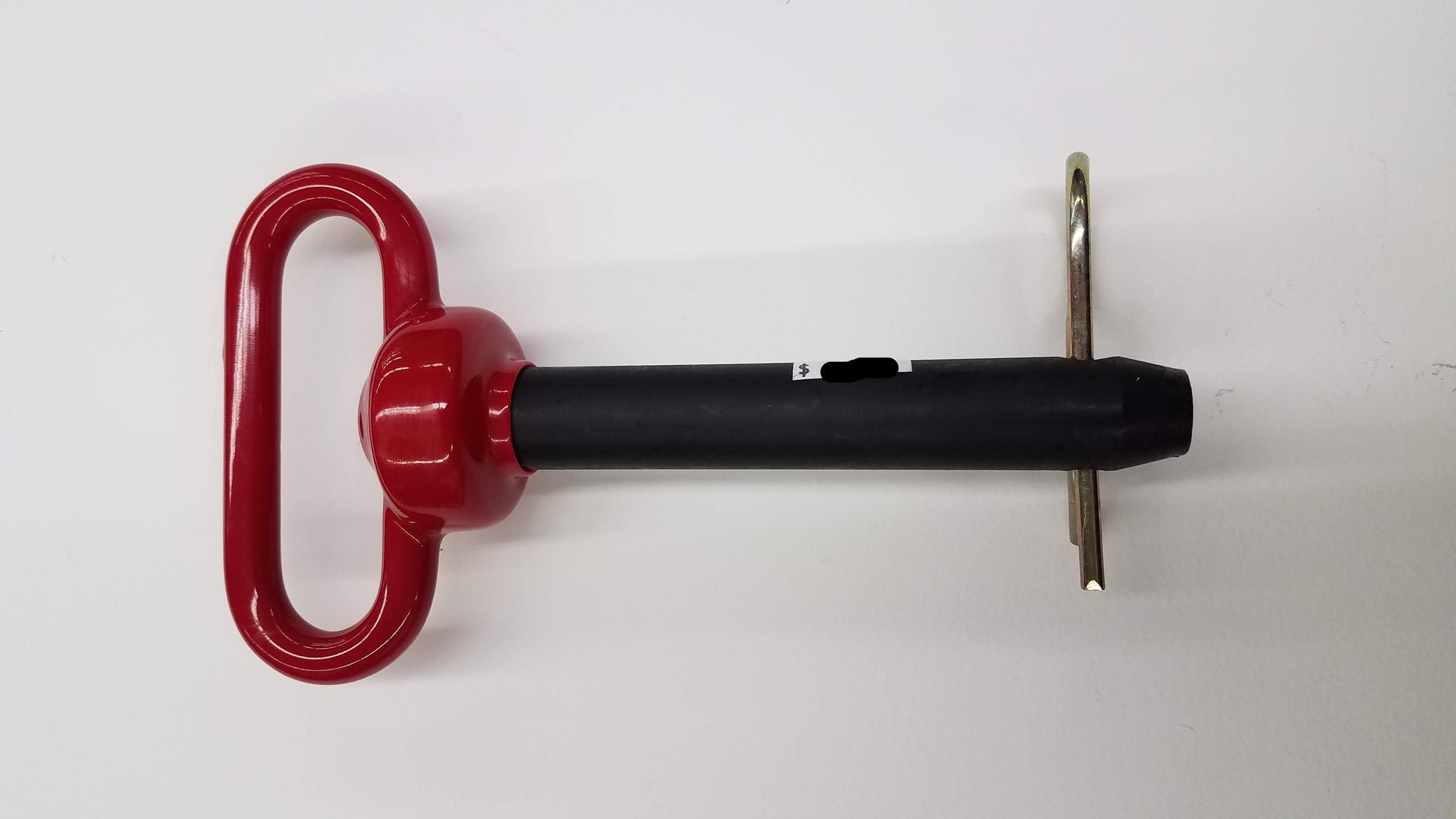 A red double HH trailer hitch pin with a black coating on the head and a hairpin clip.