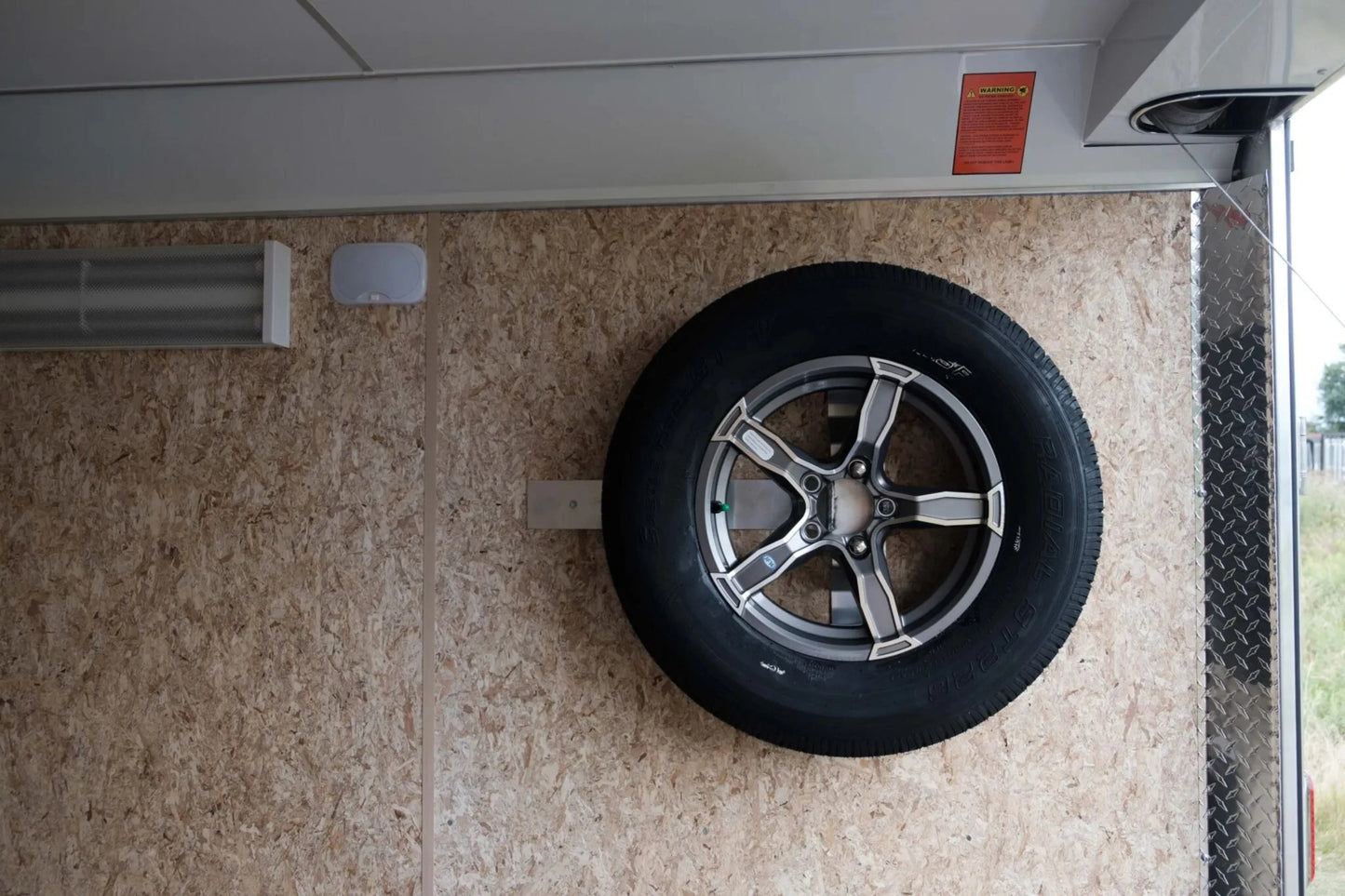 Tire mounted on a wall inside a vehicle