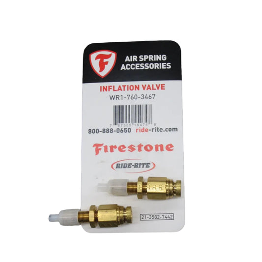 Two brass inflation valves on a Firestone branded card against a white background