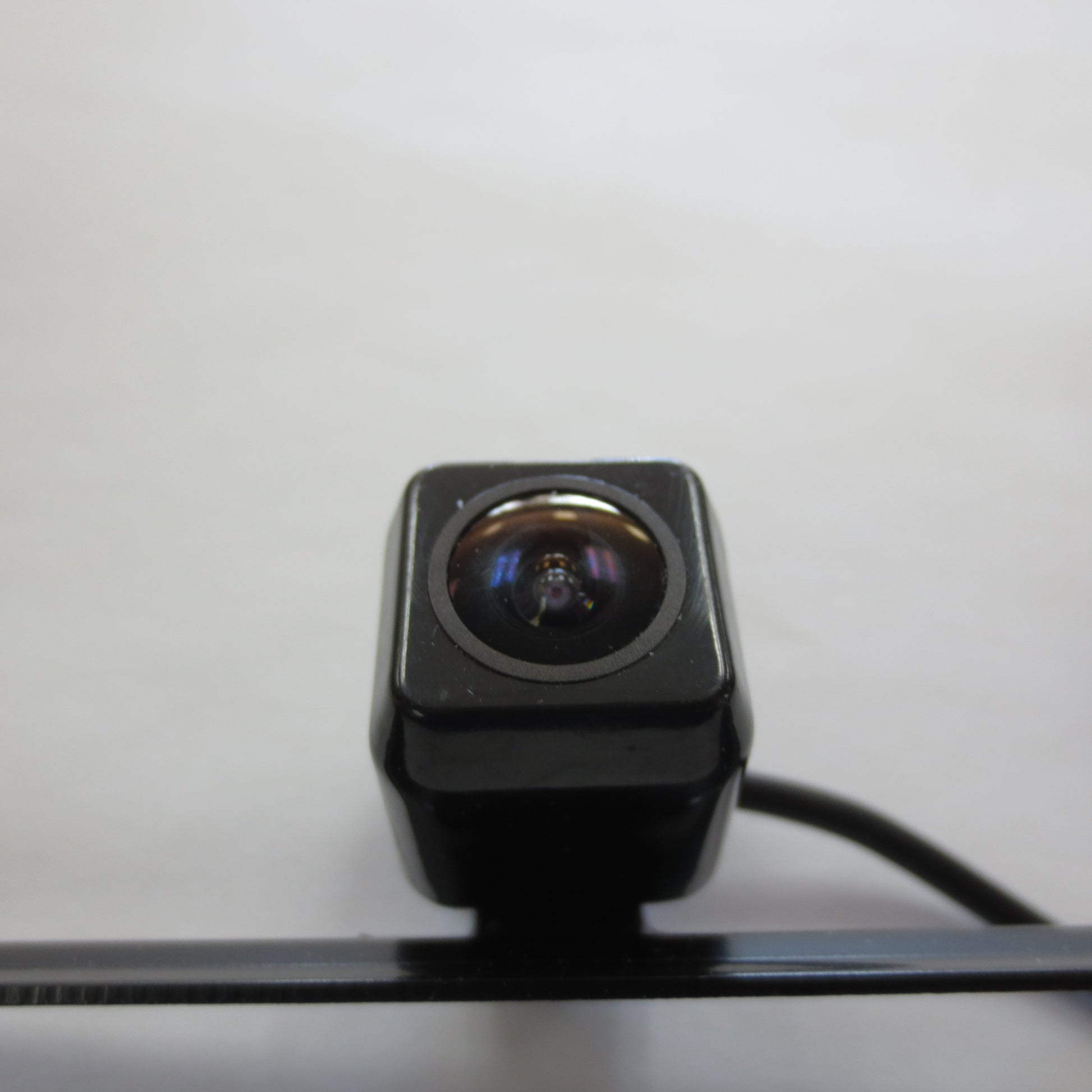 Black camera lens on a white background