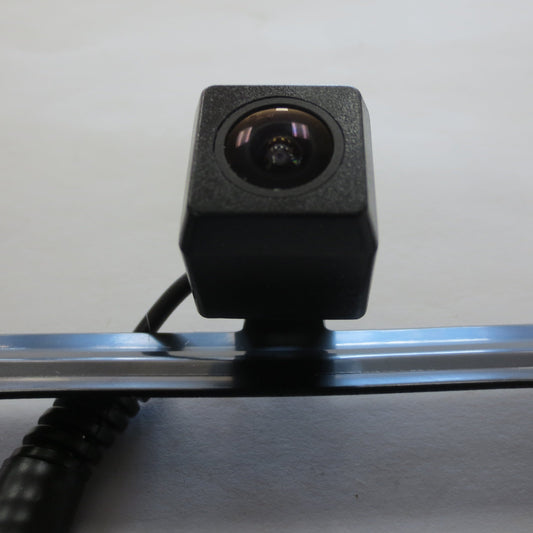 Truck bed camera system mounted on a metal surface with a plain background