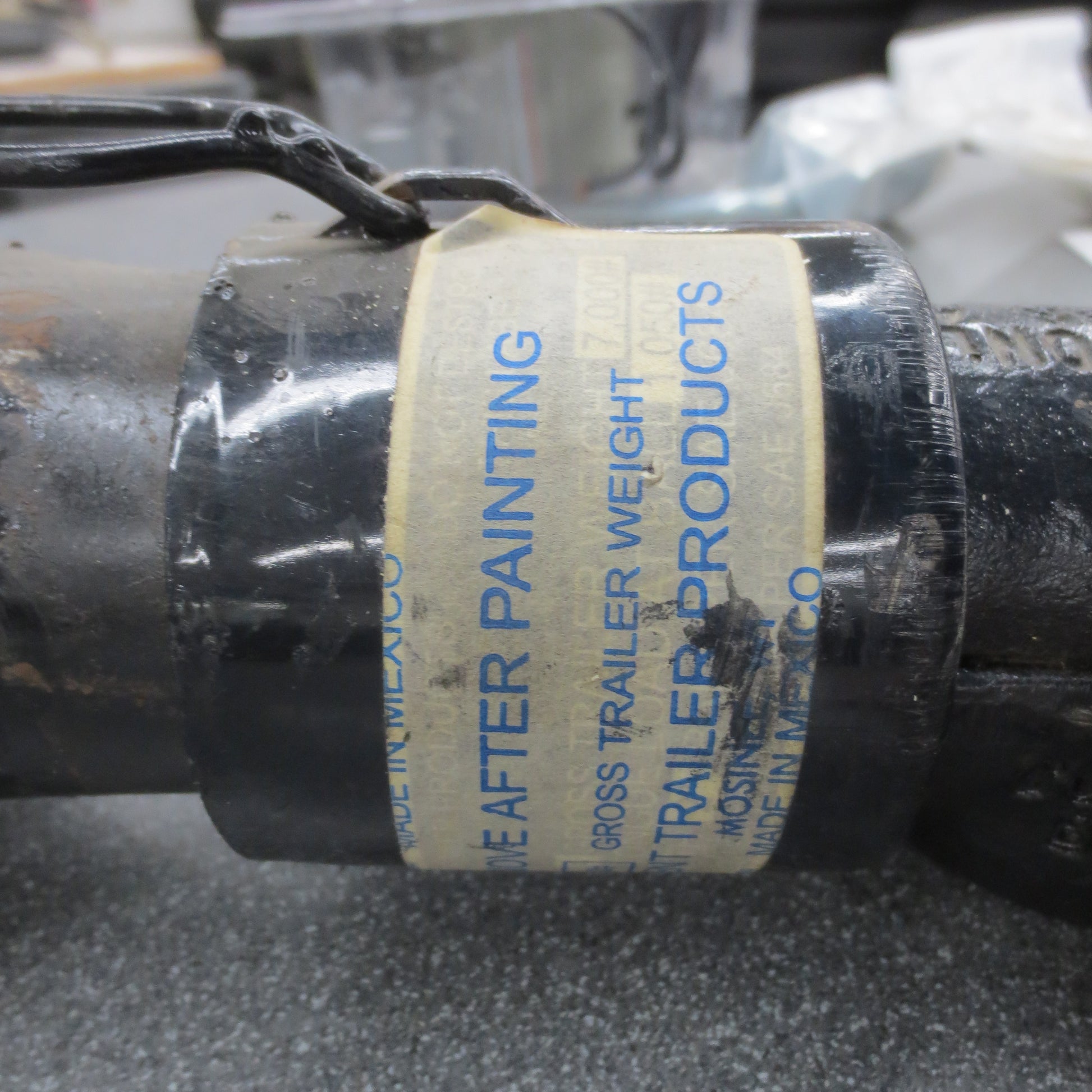 Label on a coupler with text about trailer products and weight.