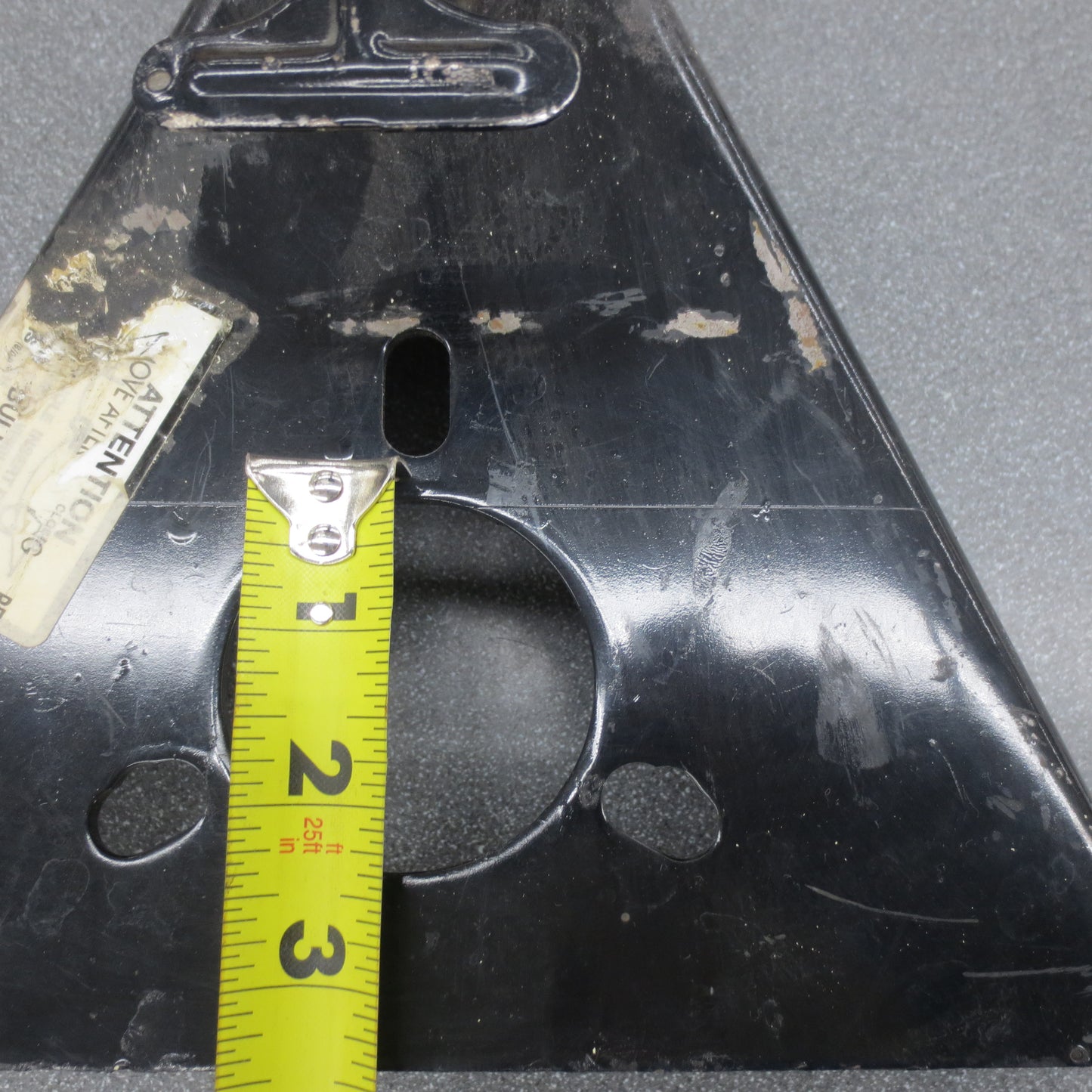 Close up of jack mounting hole with tape measure.