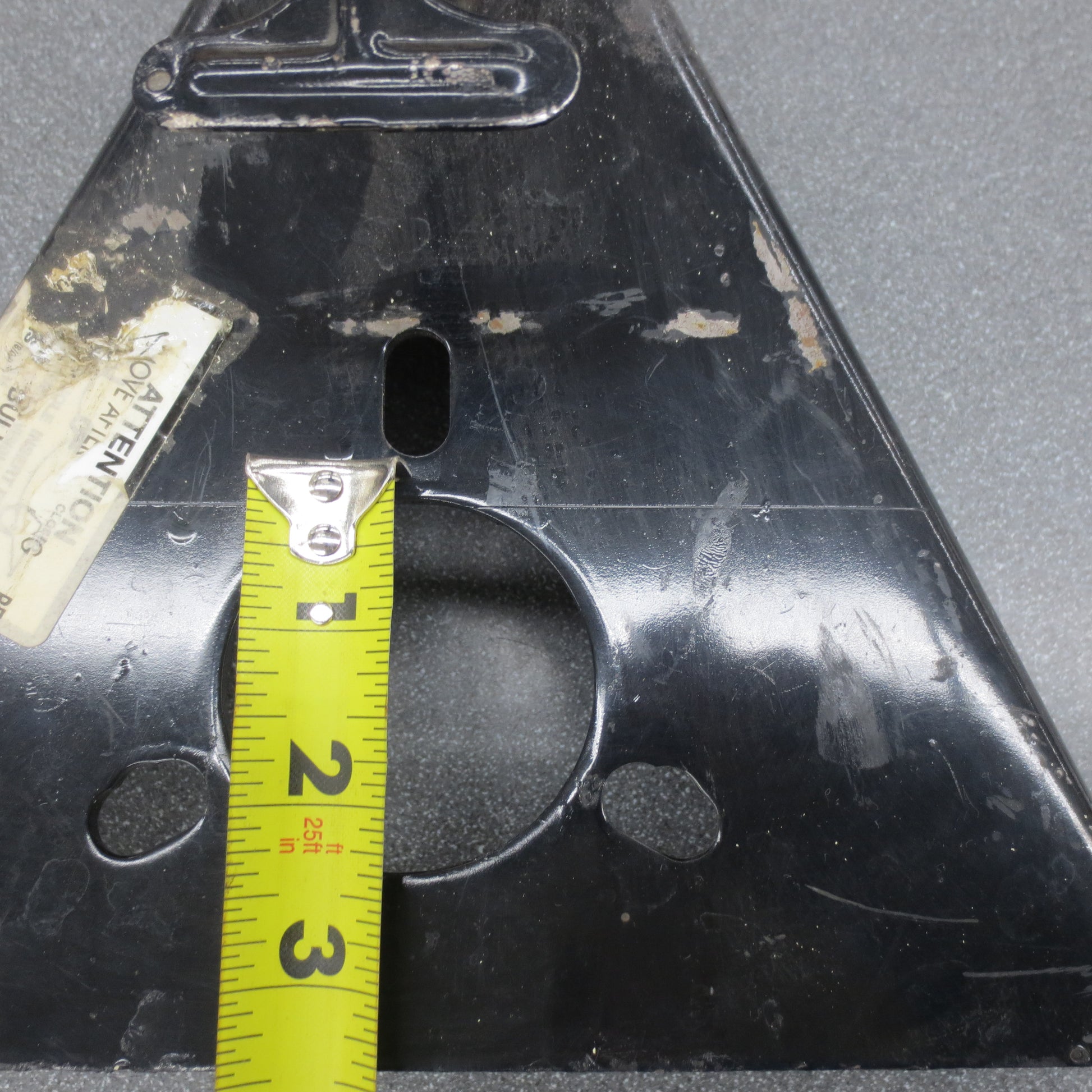 Close up of jack mounting hole with tape measure.