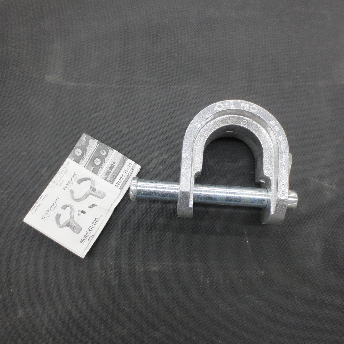 Metal lock and its packaging on a dark surface