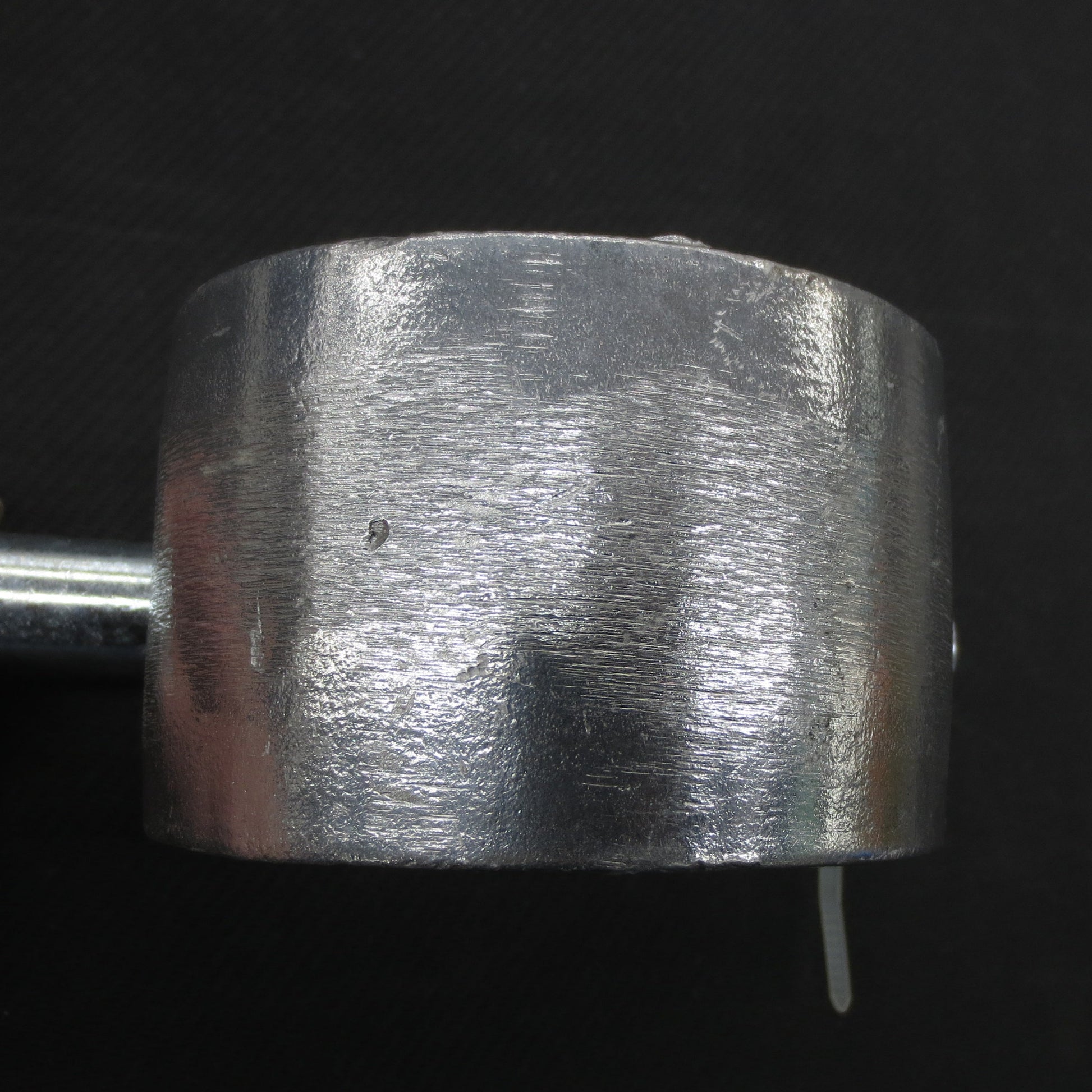 Metal king pin lock on a black background