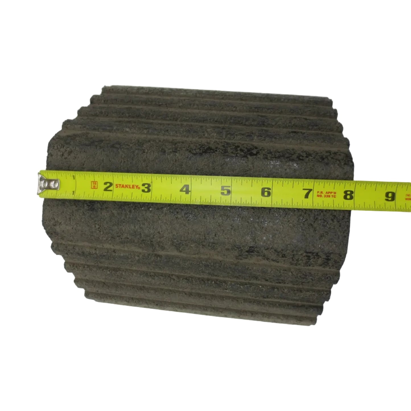 A black rubber wheel chock with a tiered step design.