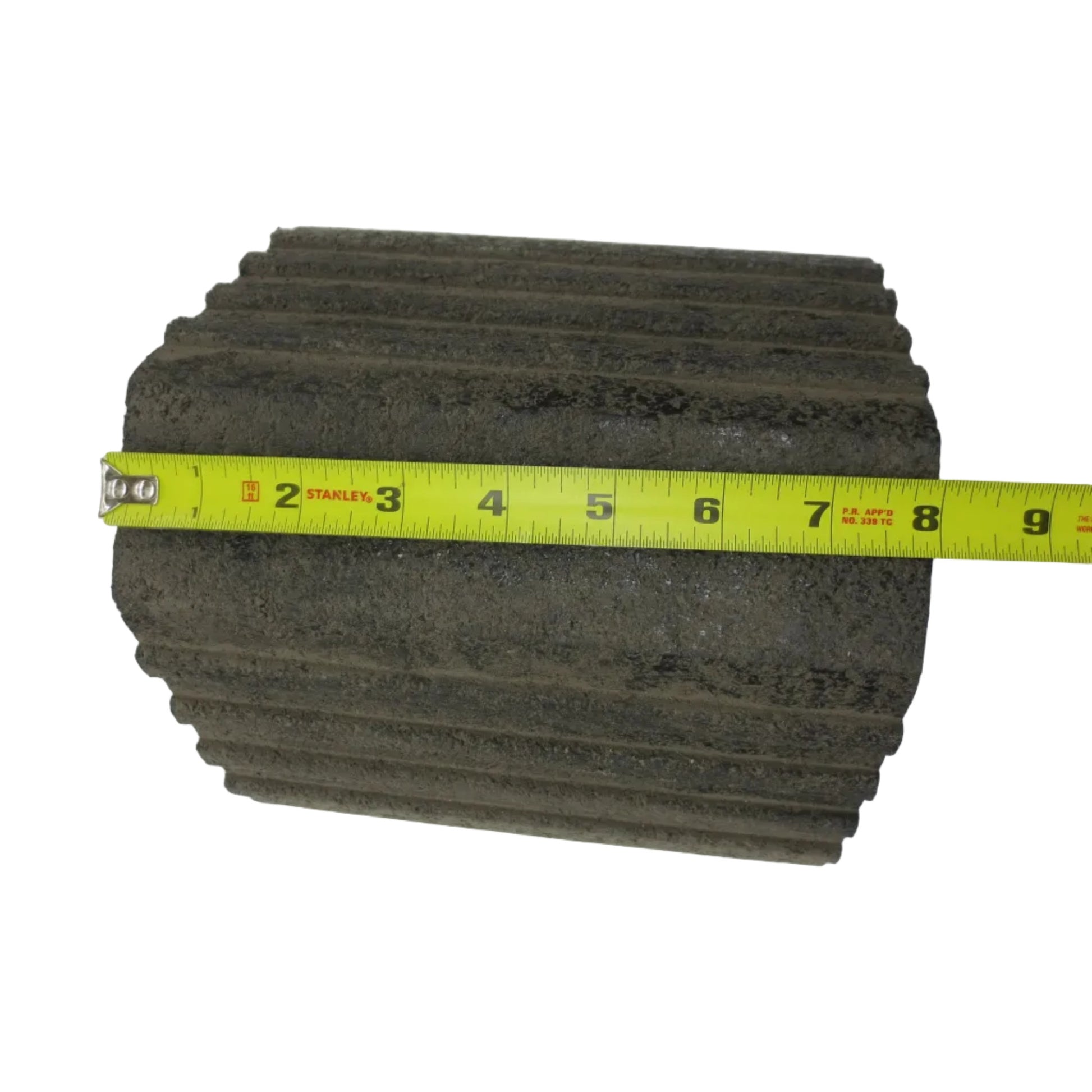 A black rubber wheel chock with a tiered step design.
